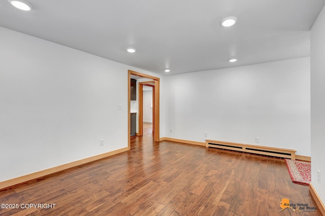 2641 W 27th Ave, Anchorage, AK 99517 - empty room featuring baseboard heating, wood finished floors, and recessed lighting