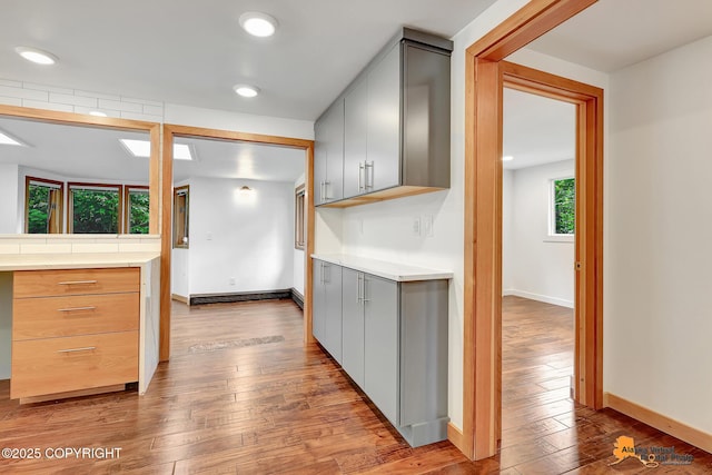 2641 W 27th Ave, Anchorage, AK 99517 - kitchen with gray cabinetry, hardwood / wood-style flooring, light countertops, and recessed lighting