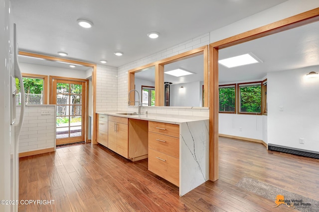2641 W 27th Ave, Anchorage, AK 99517 - kitchen with wood finished floors, light countertops, healthy amount of natural light, and recessed lighting