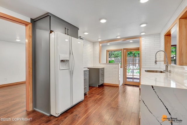 2641 W 27th Ave, Anchorage, AK 99517 - kitchen featuring white fridge with ice dispenser, gray cabinets, dark wood-style floors, light stone counters, and recessed lighting