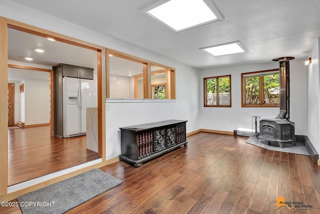 2641 W 27th Ave, Anchorage, AK 99517 - living room featuring wood finished floors and a wood stove