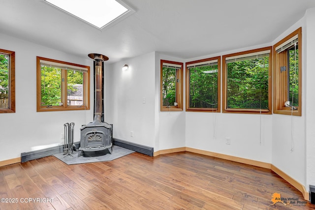 2641 W 27th Ave, Anchorage, AK 99517 - workout area featuring a wood stove and hardwood / wood-style flooring