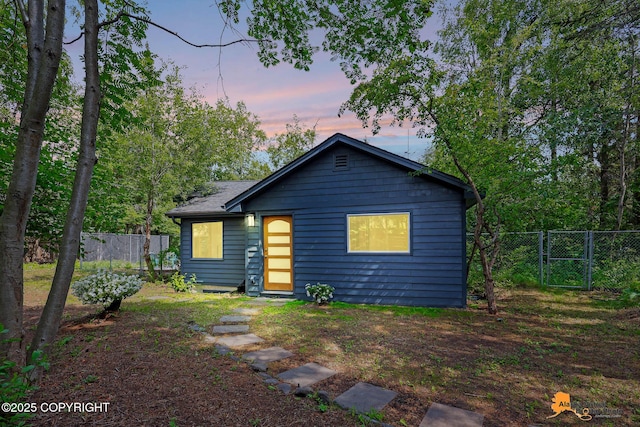 2641 W 27th Ave, Anchorage, AK 99517 - back of house at dusk featuring a gate