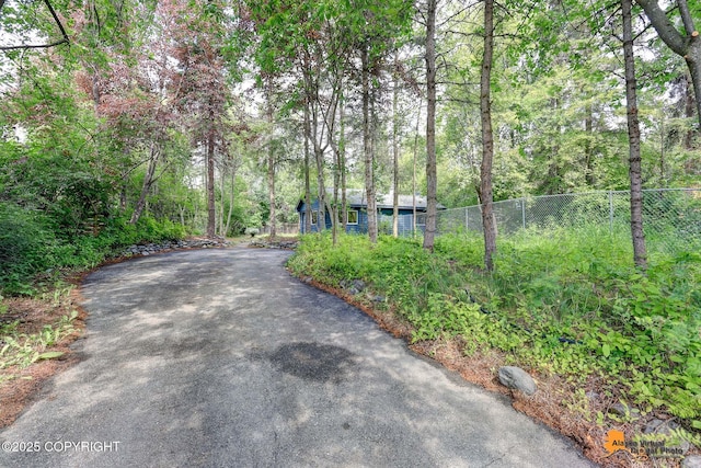 2641 W 27th Ave, Anchorage, AK 99517 - view of asphalt driveway with a view of trees
