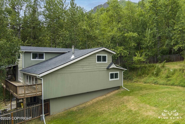 22432 Glacier View Dr, Eagle River, AK 99577 - view of side of property featuring a wooden deck, a shingled roof, and a forest view