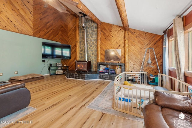 22432 Glacier View Dr, Eagle River, AK 99577 - living room featuring a wood stove, wood finished floors, and wooden walls