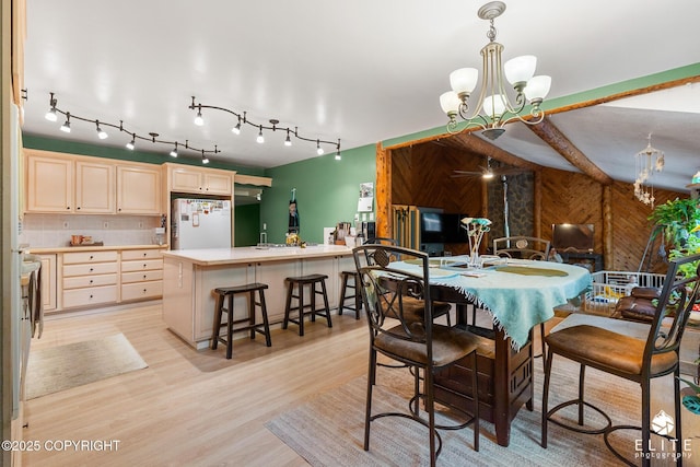 22432 Glacier View Dr, Eagle River, AK 99577 - dining area featuring a chandelier, wooden walls, and light wood-type flooring