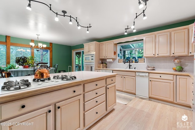 22432 Glacier View Dr, Eagle River, AK 99577 - kitchen with a chandelier, white appliances, light countertops, light wood-style flooring, and decorative light fixtures