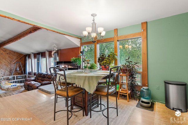 22432 Glacier View Dr, Eagle River, AK 99577 - dining space with wood walls, wood finished floors, a chandelier, and beamed ceiling