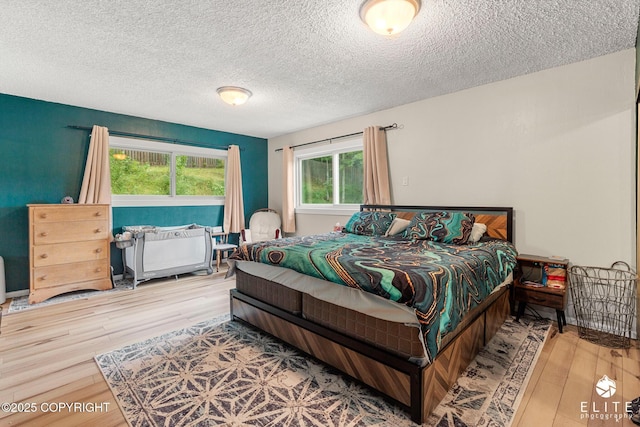22432 Glacier View Dr, Eagle River, AK 99577 - bedroom featuring wood finished floors and a textured ceiling