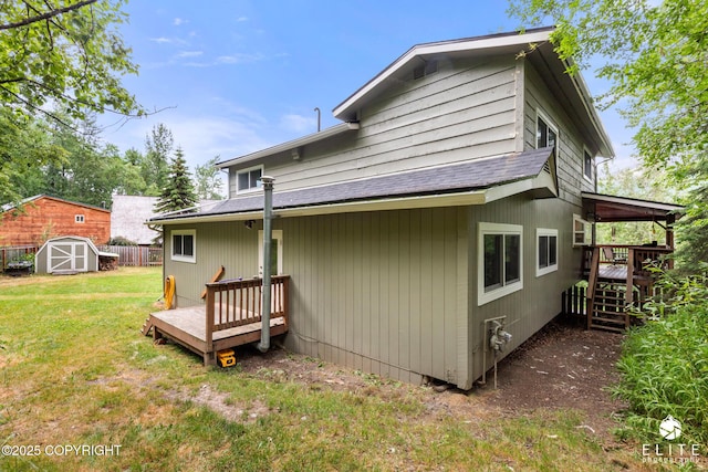 22432 Glacier View Dr, Eagle River, AK 99577 - back of house with roof with shingles, a deck, and a storage unit