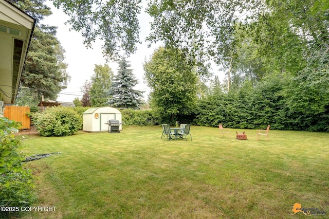 4905 Roger Dr, Anchorage, AK 99507 - view of yard featuring a storage shed and an outdoor fire pit