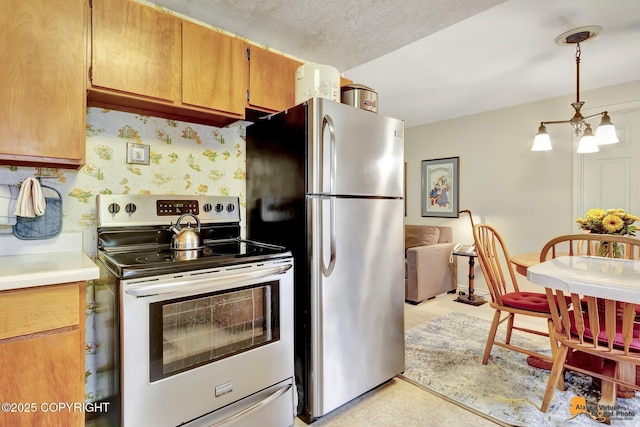 4905 Roger Dr, Anchorage, AK 99507 - kitchen featuring stainless steel appliances, light countertops, a chandelier, and hanging light fixtures