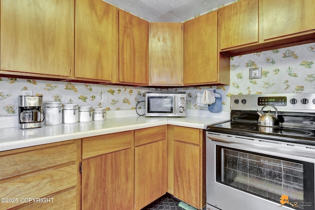 4905 Roger Dr, Anchorage, AK 99507 - kitchen with stainless steel appliances and light countertops