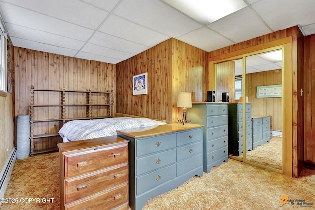 4905 Roger Dr, Anchorage, AK 99507 - carpeted bedroom with a paneled ceiling, a closet, wooden walls, and baseboard heating