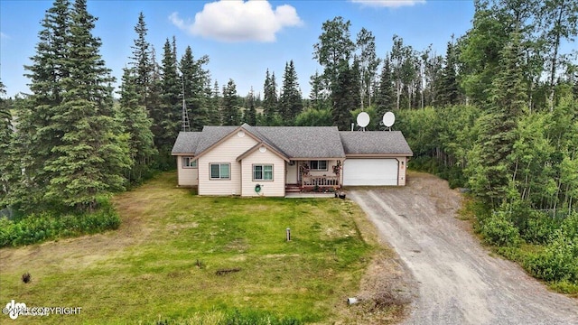 34443 Matanuska St, Soldotna, AK 99669 - ranch-style home with dirt driveway, a garage, a front lawn, and a view of trees