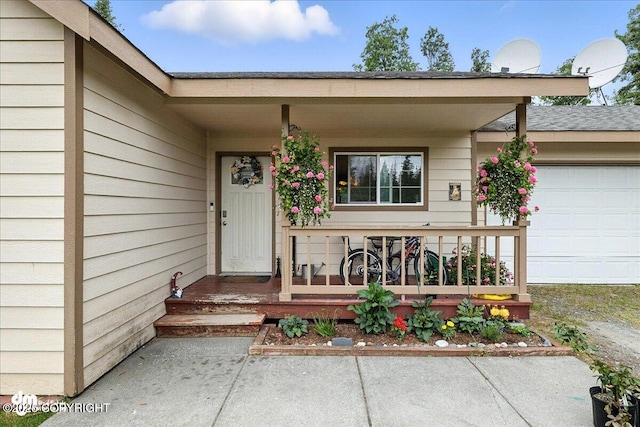 34443 Matanuska St, Soldotna, AK 99669 - doorway to property with covered porch, an attached garage, and a shingled roof