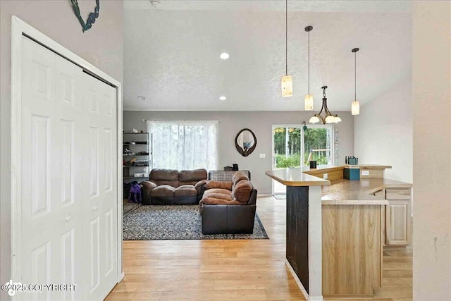 34443 Matanuska St, Soldotna, AK 99669 - kitchen featuring light wood-style floors, hanging light fixtures, open floor plan, and recessed lighting