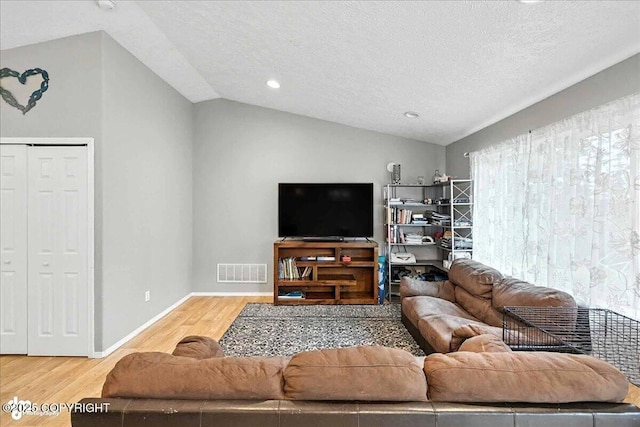 34443 Matanuska St, Soldotna, AK 99669 - living room with wood finished floors, lofted ceiling, a textured ceiling, and recessed lighting
