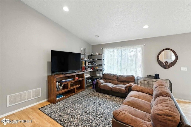 34443 Matanuska St, Soldotna, AK 99669 - living room with a textured ceiling, wood finished floors, recessed lighting, and lofted ceiling