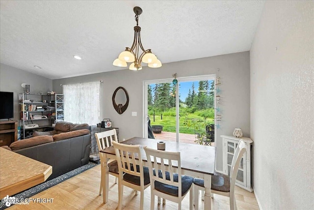 34443 Matanuska St, Soldotna, AK 99669 - dining area featuring healthy amount of natural light, a textured ceiling, a chandelier, light wood finished floors, and a textured wall