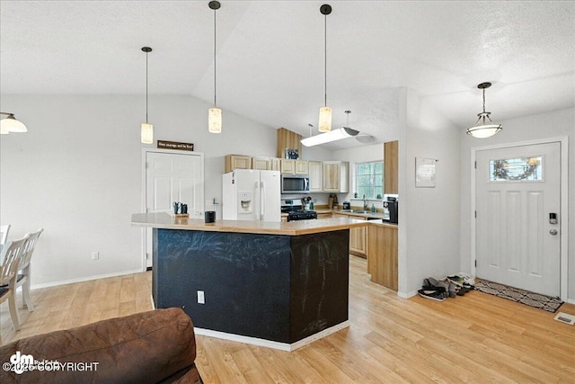 34443 Matanuska St, Soldotna, AK 99669 - kitchen featuring light countertops, white refrigerator with ice dispenser, light wood-style floors, a center island, and black gas range