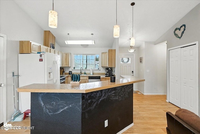 34443 Matanuska St, Soldotna, AK 99669 - kitchen featuring vaulted ceiling, light countertops, light wood-type flooring, appliances with stainless steel finishes, and pendant lighting