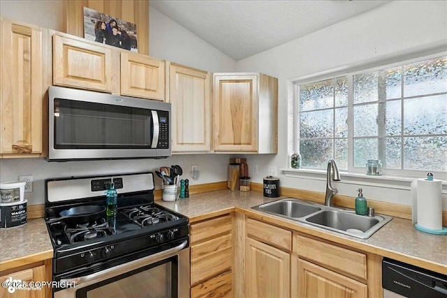 34443 Matanuska St, Soldotna, AK 99669 - kitchen with light brown cabinets, stainless steel appliances, vaulted ceiling, light countertops, and a textured ceiling