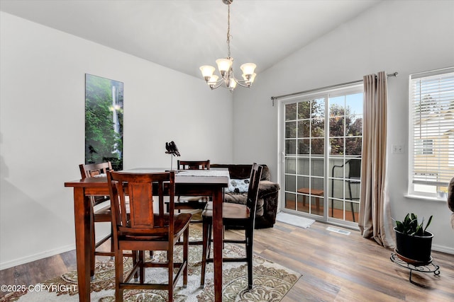 5586 Sapphire Loop # 55B, Anchorage, AK 99504 - dining area with lofted ceiling, a chandelier, and wood finished floors