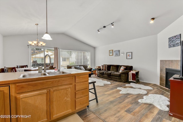 5586 Sapphire Loop # 55B, Anchorage, AK 99504 - kitchen featuring open floor plan, lofted ceiling, wood finished floors, pendant lighting, and a chandelier