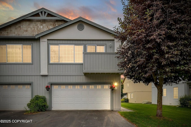 5586 Sapphire Loop # 55B, Anchorage, AK 99504 - view of front facade featuring an attached garage, a lawn, and driveway