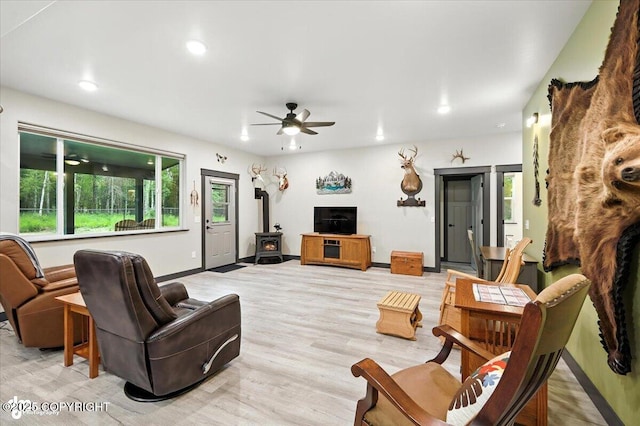 5551 N Wildwood Dr, Wasilla, AK 99654 - living room with a wood stove, a ceiling fan, recessed lighting, and light wood finished floors