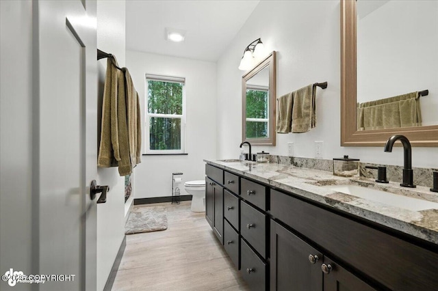 5551 N Wildwood Dr, Wasilla, AK 99654 - bathroom featuring double vanity and wood finished floors