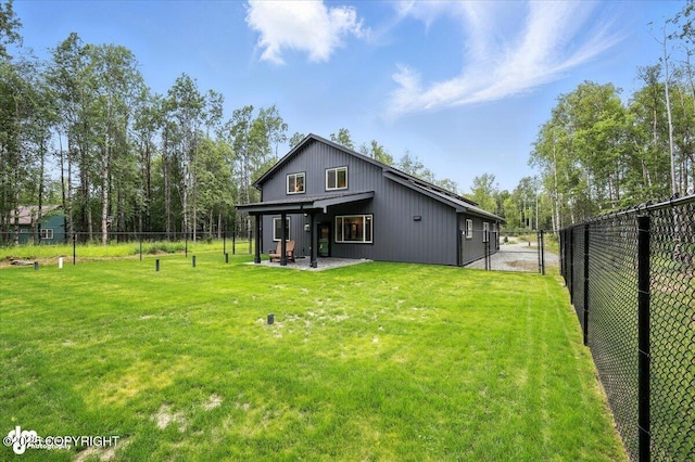 5551 N Wildwood Dr, Wasilla, AK 99654 - rear view of property featuring a fenced backyard and a patio area