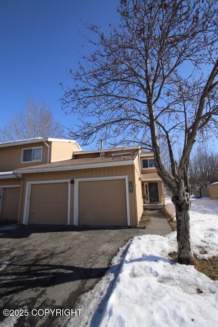 1705 Morningtide Ct, Anchorage, AK 99501 - view of front facade with asphalt driveway and a garage