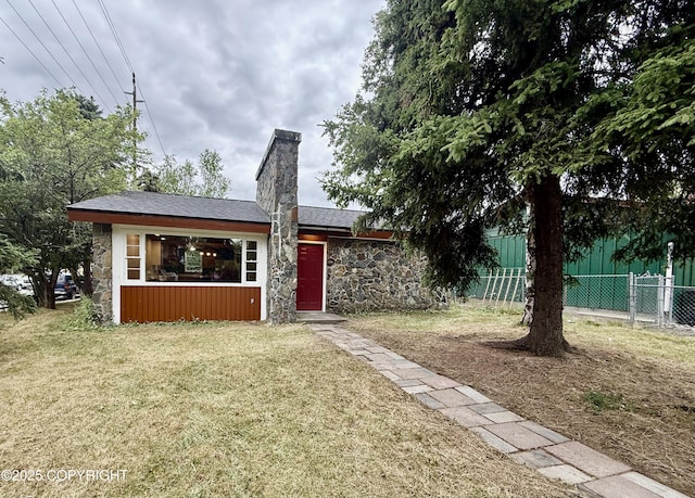 290 Park St, Anchorage, AK 99508 - view of front of home with stone siding and a chimney