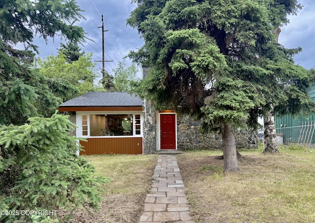 290 Park St, Anchorage, AK 99508 - view of front of property featuring stone siding and roof with shingles