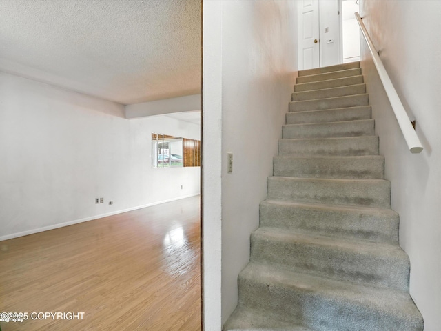 9801 Whitefish Cir, Anchorage, AK 99515 - staircase with wood finished floors and a textured ceiling