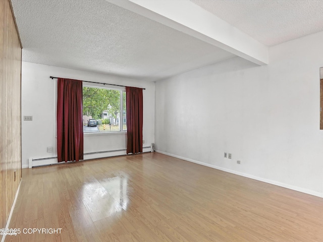 9801 Whitefish Cir, Anchorage, AK 99515 - unfurnished room with wood finished floors, a textured ceiling, and baseboard heating