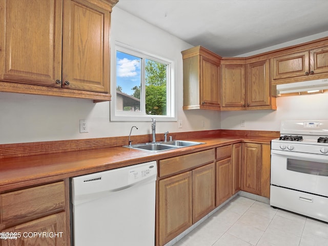 9801 Whitefish Cir, Anchorage, AK 99515 - kitchen featuring white appliances, under cabinet range hood, light tile patterned flooring, and brown cabinets