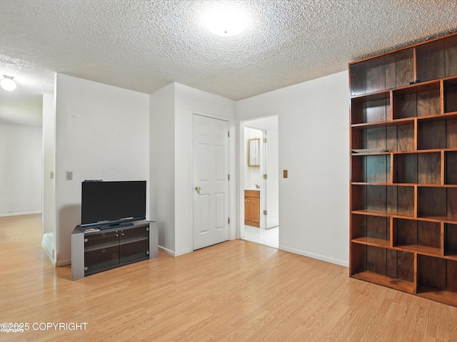9801 Whitefish Cir, Anchorage, AK 99515 - unfurnished living room with a textured ceiling and wood finished floors