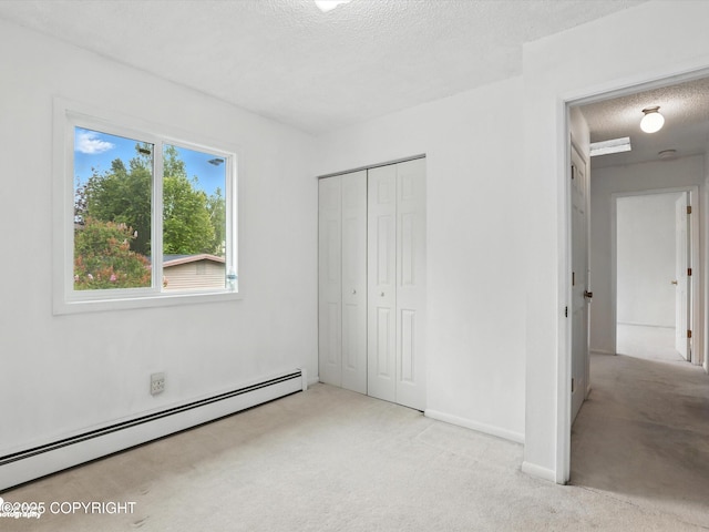 9801 Whitefish Cir, Anchorage, AK 99515 - unfurnished bedroom featuring a baseboard heating unit, a textured ceiling, carpet flooring, and a closet