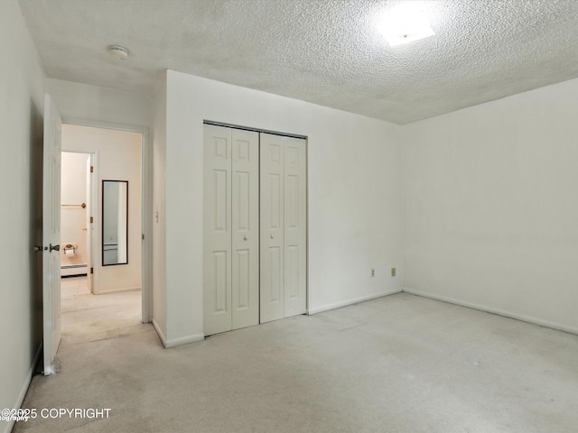 9801 Whitefish Cir, Anchorage, AK 99515 - unfurnished bedroom featuring carpet floors, baseboard heating, a closet, and a textured ceiling