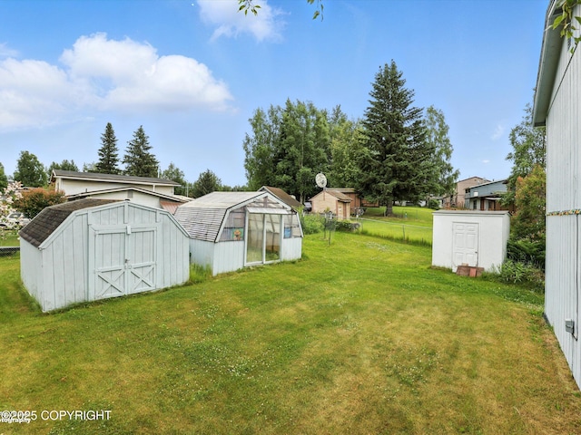 9801 Whitefish Cir, Anchorage, AK 99515 - view of green lawn with a storage shed and an exterior structure