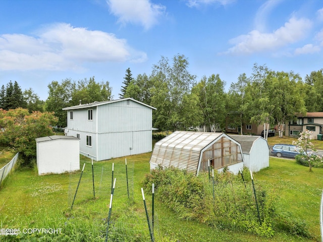9801 Whitefish Cir, Anchorage, AK 99515 - view of yard with a greenhouse, an outbuilding, and view of wooded area