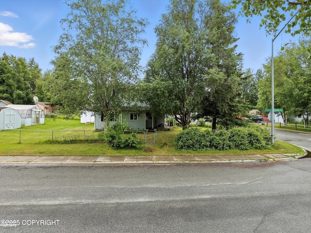 9801 Whitefish Cir, Anchorage, AK 99515 - view of property hidden behind natural elements featuring a shed