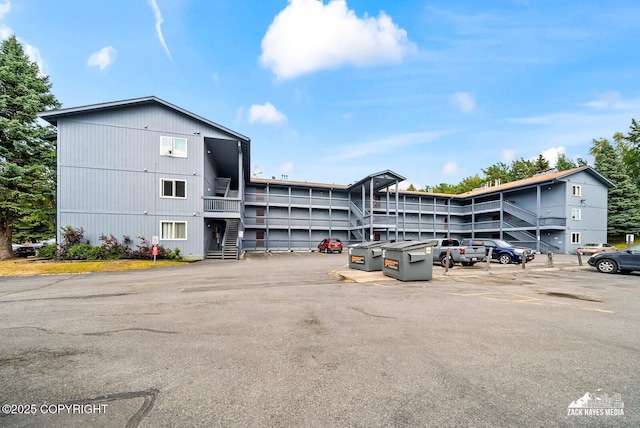 8641 Blackberry St # 6B, Anchorage, AK 99502 - view of building exterior with stairway and uncovered parking