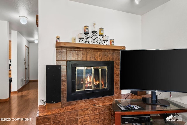 8641 Blackberry St # 6B, Anchorage, AK 99502 - detailed view of a brick fireplace and wood finished floors