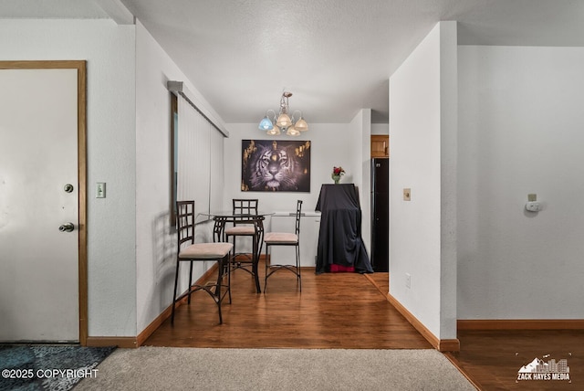 8641 Blackberry St # 6B, Anchorage, AK 99502 - dining space with a chandelier and wood finished floors