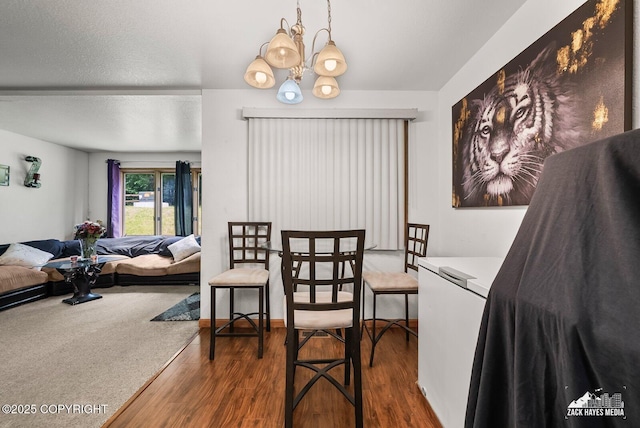 8641 Blackberry St # 6B, Anchorage, AK 99502 - dining room featuring wood finished floors and a chandelier